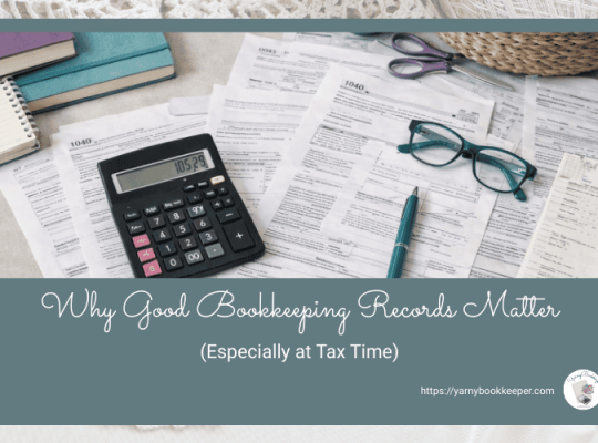 Handmade business owner reviewing bookkeeping records and paperwork at a desk with yarn and tools, preparing for tax time.