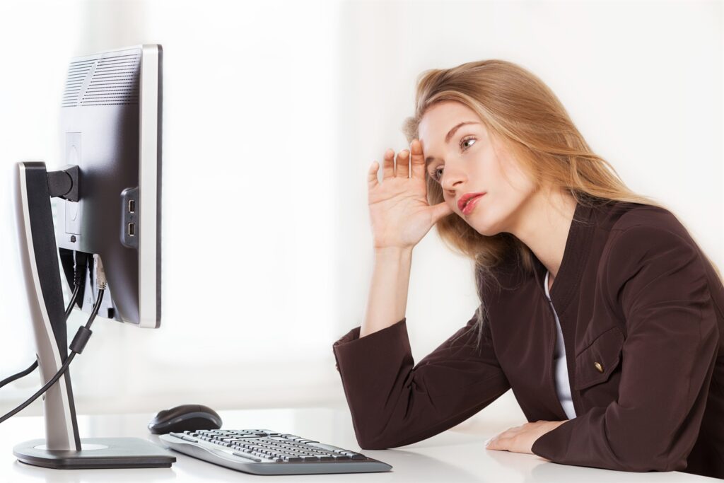 woman business owner staring at computer in confusion